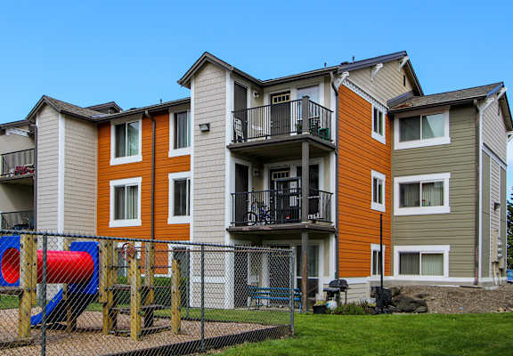Apartment building with a playground in front.