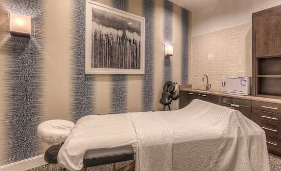 a room with a bed and a painting on the wall  at EdgeWater at City Center, Lenexa, KS, 66219