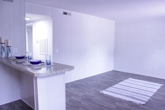 an empty room with a counter and a mirror in it