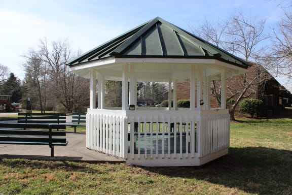 a gazebo in a park with benches