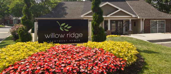 the exterior of willow ridge community center with a sign in front of a house  at Willow Ridge Apartments, North Carolina, 28210