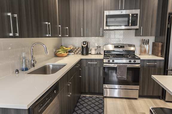 a kitchen with stainless steel appliances and wooden cabinets