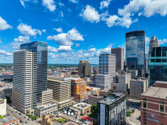 a city skyline with skyscrapers and a blue sky