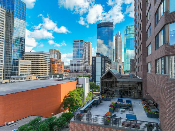 a view of the city skyline from a rooftop terrace of a building