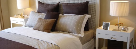 Brown and tan bed with nightstands and lamps