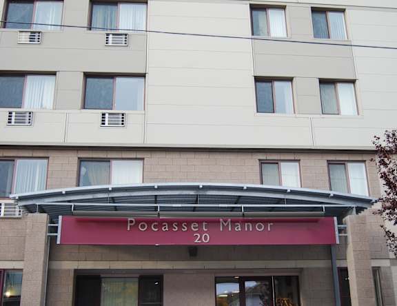 The Pocasset Manor is a large building with a red awning.