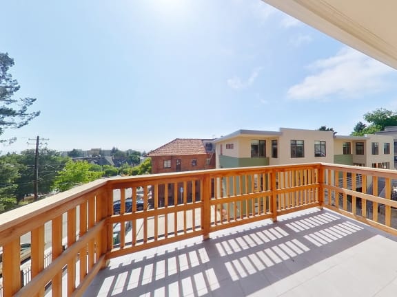 the view from the deck of a home with a wooden railing
