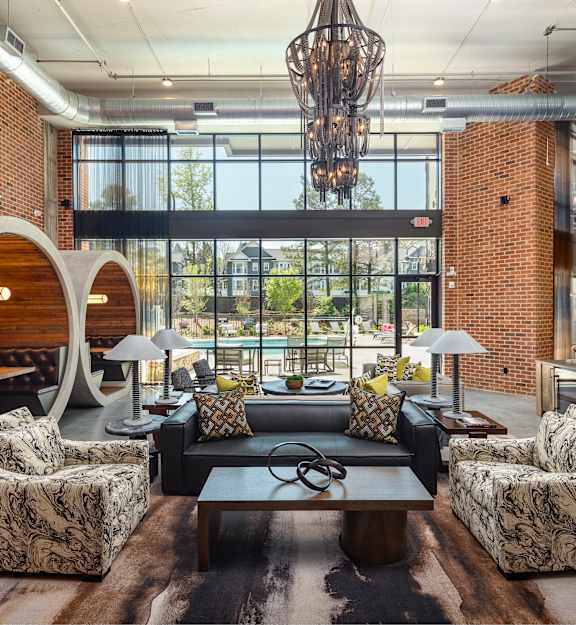 a living room with couches and chairs and a table
