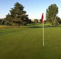 a golf course with a red flag on it