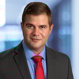 a man wearing a suit and red tie