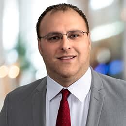 a man wearing glasses and a suit and tie