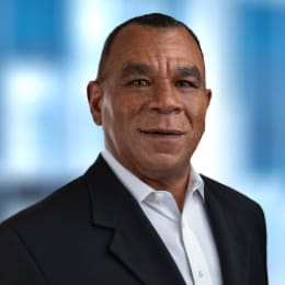 a man in a suit and tie smiling
