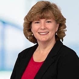 a woman in a red shirt and a black jacket