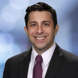 a young man in a suit and tie smiling