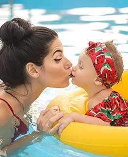Lifestyle photo of mother and daughter at the pool
