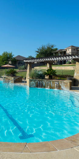 a large swimming pool in front of a house