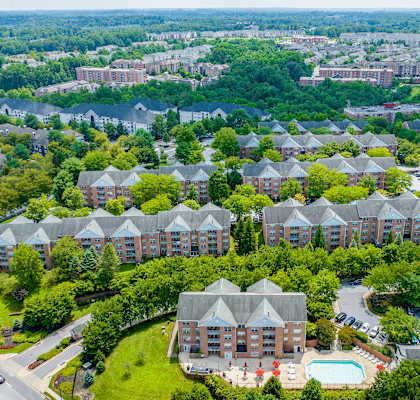 an aerial view of a building surrounded by trees at Cascades Overlook Apts., Owings Mills, 21117