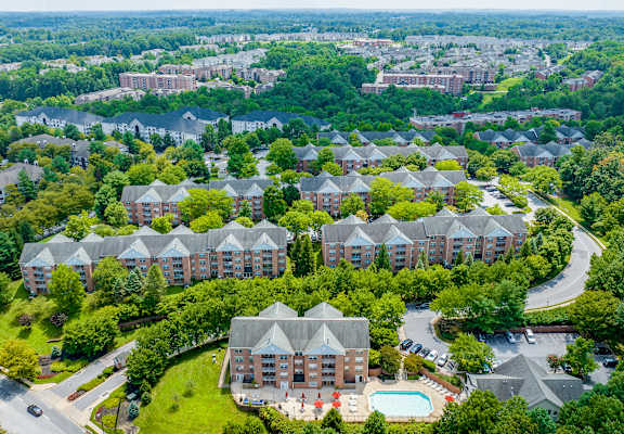 an aerial view of a building surrounded by trees at Cascades Overlook Apts., Owings Mills, 21117