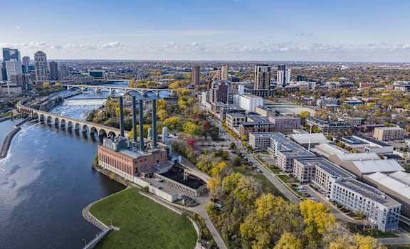an aerial view of a city with a river and a bridge