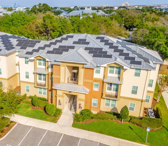 an aerial view of an apartment complex with solar panels on the roof