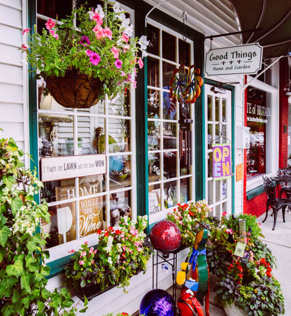 a city street lined with shops and flowers