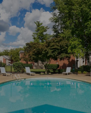 Swimming pool with lounge seating - East Chase Apartments