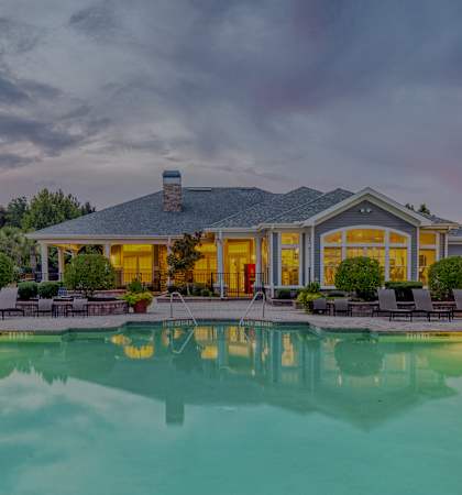Courtney Station - Resort-style pool with clubhouse exterior at dusk