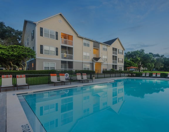The Colony at Deerwood Apartments - Resort-style pool with lounge seating