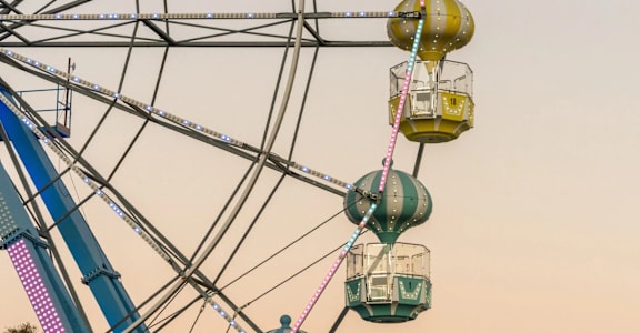 A ferris wheel with multiple gondolas suspended on cables at The Teale Siesta Lago in Kissimmee, FL, 34746