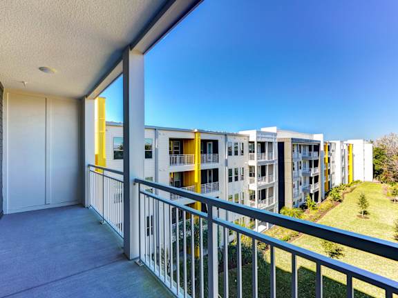 a balcony with a large window and a door