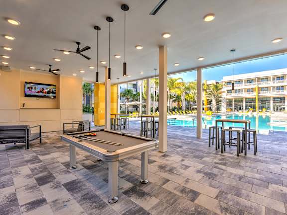 Pavilion with outdoor pool table overlooking the pool