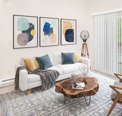 a living room with a white couch and blue and yellow pillows at Veri at Timberhill, Corvallis, OR