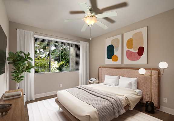 a bedroom with a bed and a ceiling fan