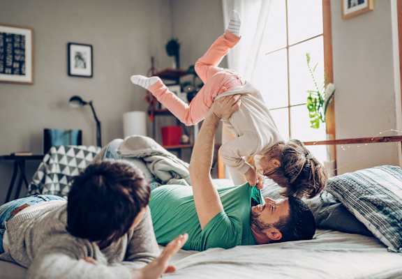 Father playing with kids in apartment at Renew Madison, Madison, Wisconsin