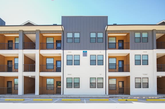 a row of apartment buildings with a street in front of them