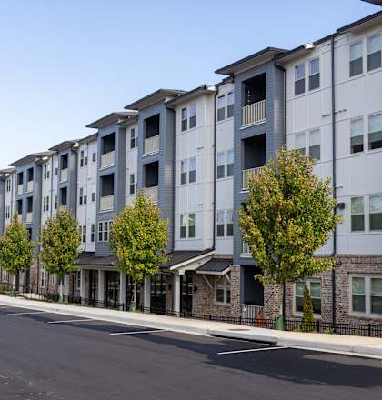 an empty street in front of an apartment building