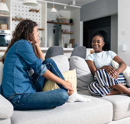 Two female roommates hanging out on couch. at Boston Lofts, Milwaukee