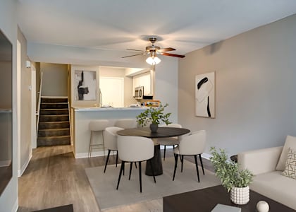 A living room with a dining table and chairs.