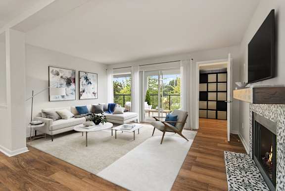a living room with couches and chairs and a fireplace