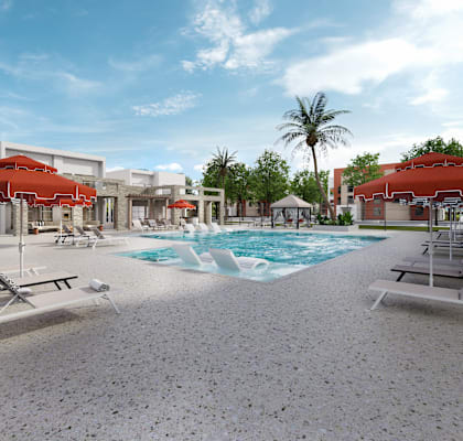 A pool area with a large swimming pool, sun loungers, and a pavilion.