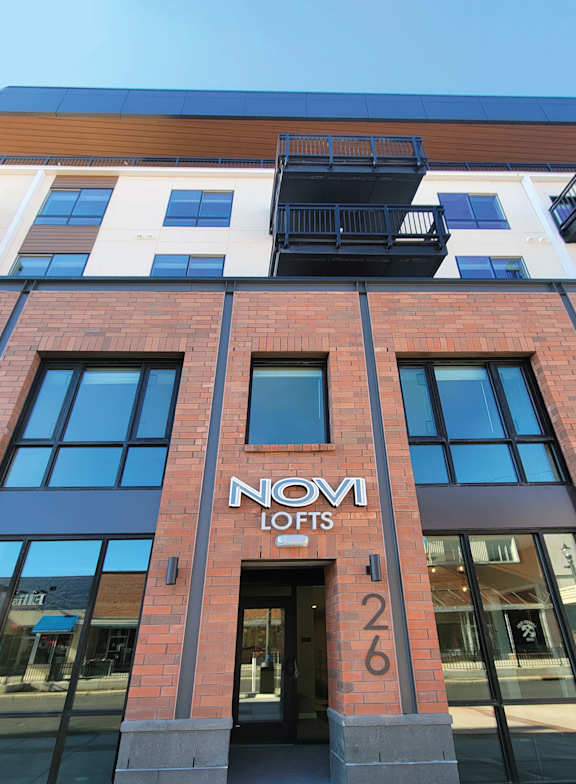 The building has a sign that says Novi Lofts 26.
