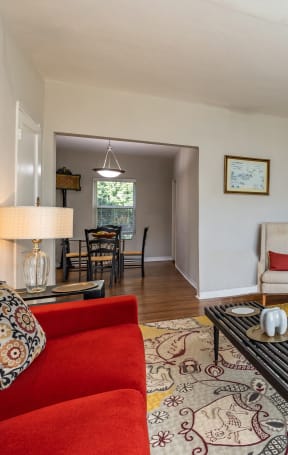 a living room with a red couch and a coffee table