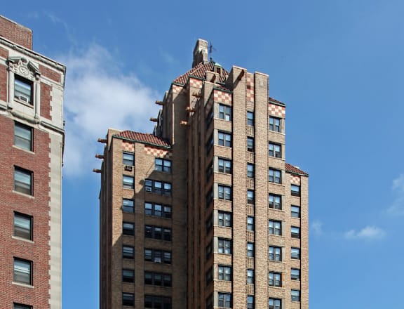 a tall building in a city with cars on the street
