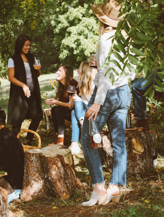 a group of people standing around a tree stump