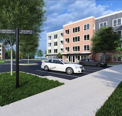 A street view of a residential area with a crosswalk and a car parked on the side of the road.