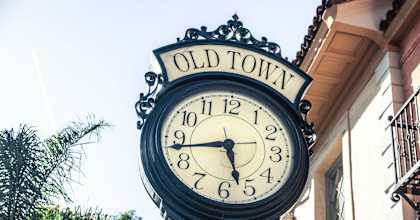 an old town clock on the side of a building