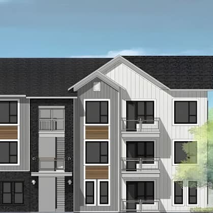 A modern apartment building with balconies and a mix of window designs.