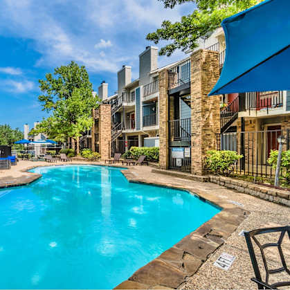 A swimming pool in a residential area surrounded by buildings.