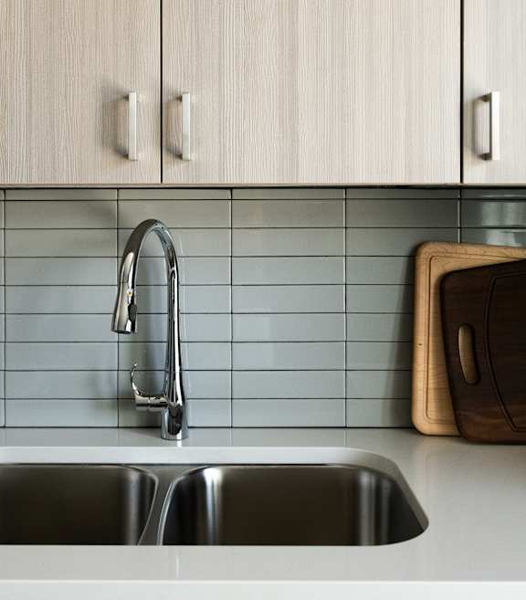 A kitchen with a sink and cabinets.
