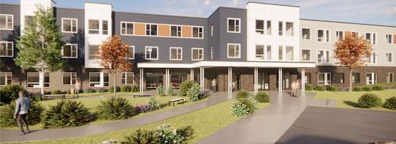 A modern apartment complex with a walkway in front.